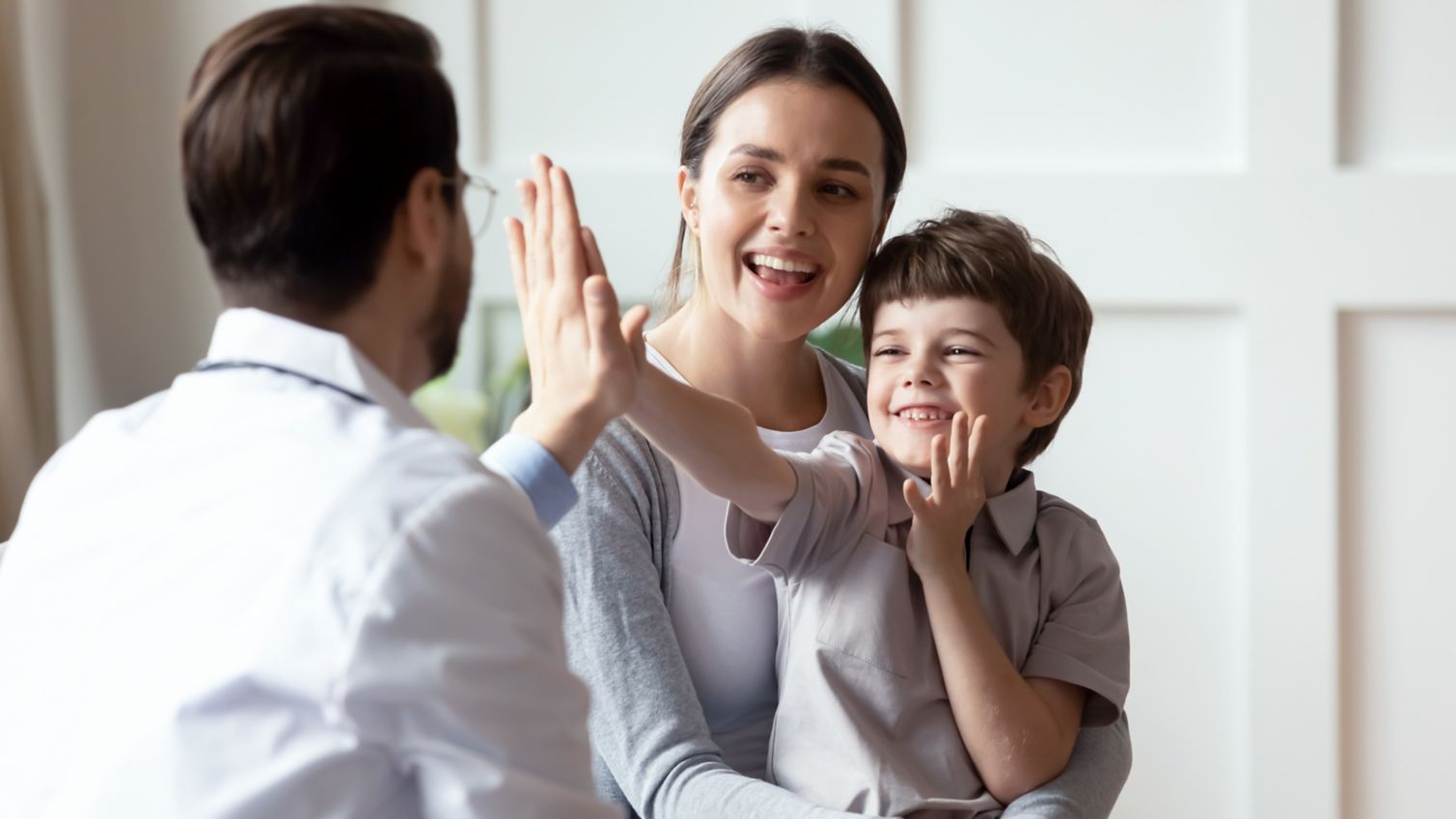 Child giving high five to healthcare professional